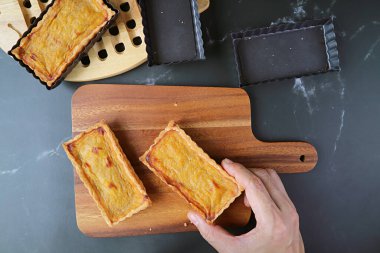 Kare şeklinde taze fırınlanmış balkabağı kek çubuğu ahşap ekmek tahtasına yerleştirilmiş.