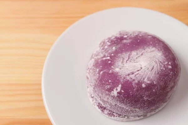 Closeup of Japanese Purple Sweet Potato Daifuku or Red Bean Paste Filling Rice Cake on White Plate