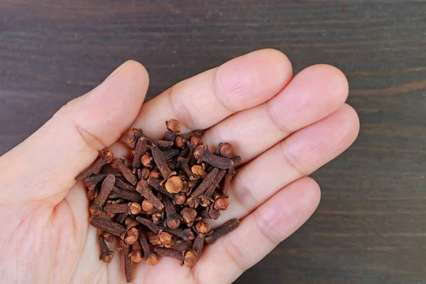 Heap Dried Cloves Hand Black Wooden Backdrop — Stock Photo, Image