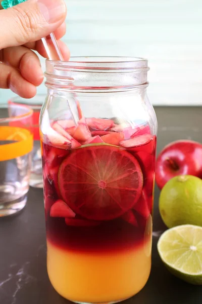 Man Hand Mix Red Wine Sangria Grass Bottle Blurry Ingredients — стокове фото