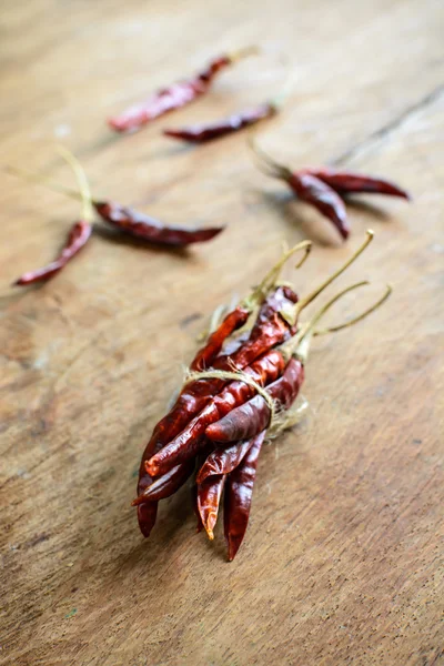 Dried chilli peppers on rustic wooden — Stock Photo, Image