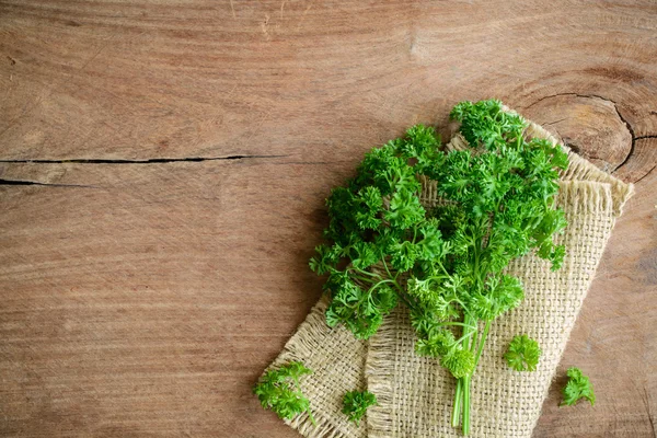 Bunch of parsley on a rustic wooden table — Stock Photo, Image