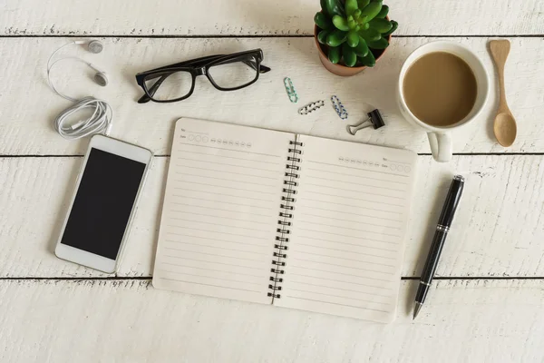 Blank notebook with earphone and a cup of coffee on white wooden — Stock Photo, Image