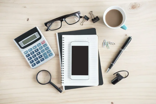 Notebook with cup of coffee on wooden desk — Stock Photo, Image