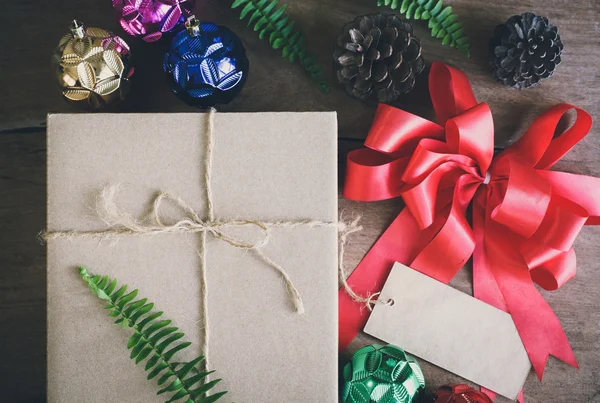 Gift box on wooden background with decorations — Stock Photo, Image