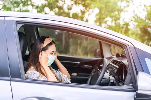 The female driver wearing surgical mask felt confident while traveling