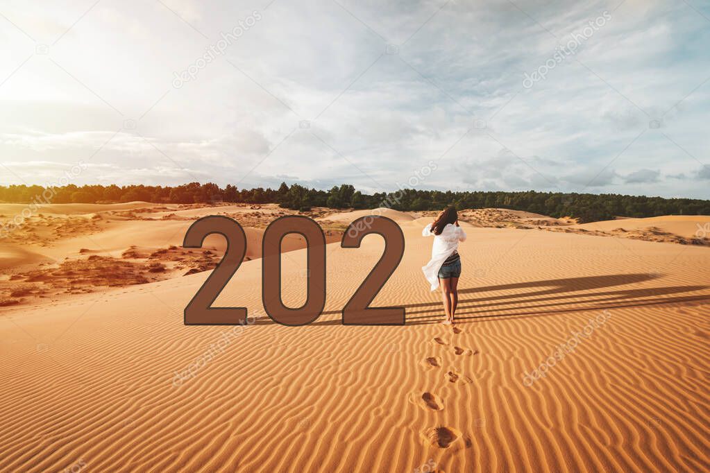 Young woman traveler walking at red sand dunes in Vietnam, 2021 Travel lifestyle concept