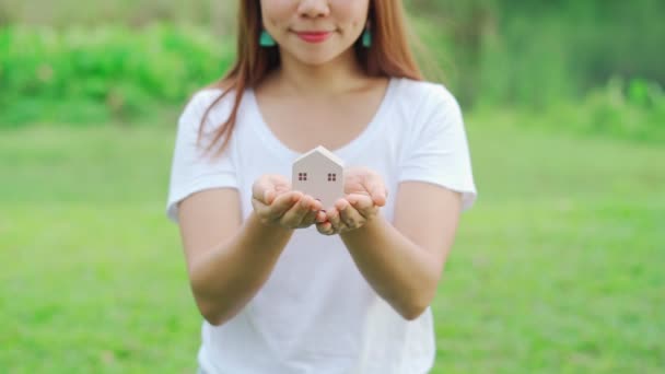 Young Woman Holding Wooden House Model Green Natural Sunlight Background — Stock Video