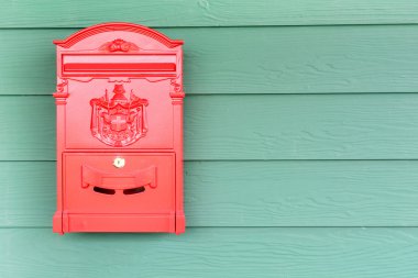 Red mailbox with green wood background clipart