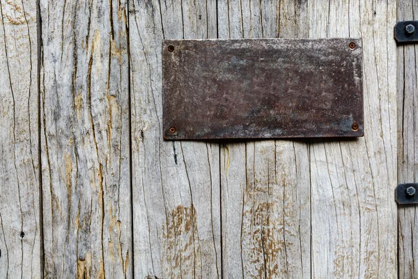 Old metal sign on wood background — Stock Photo, Image