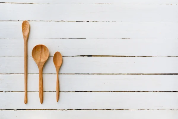 wooden spoon on white wooden table