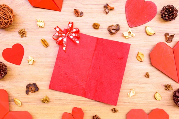 Red heart shape paper on wooden table — Stock Photo, Image