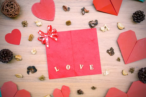 Red heart shape paper on wooden table — Stock Photo, Image