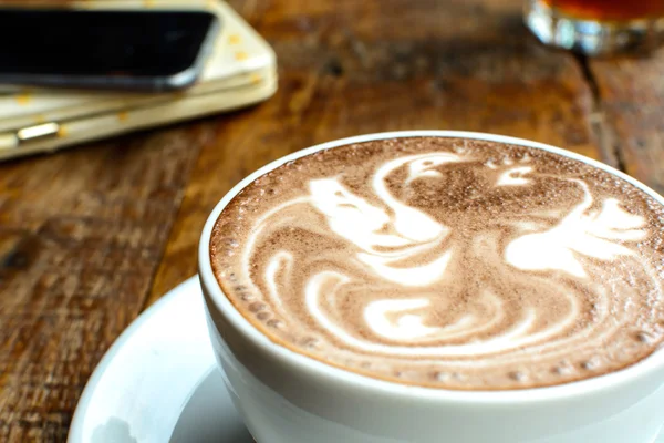 Close up of Cup of coffee on wooden table — Stock Photo, Image