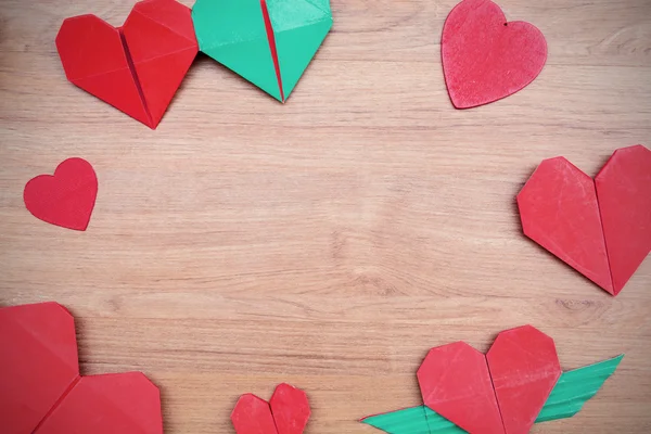 Papel rojo en forma de corazón sobre mesa de madera —  Fotos de Stock