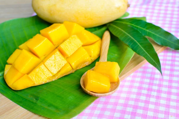 Yellow mango on wooden table — Stock Photo, Image