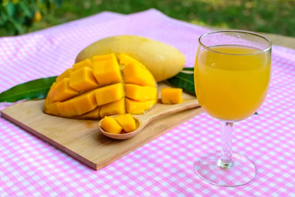 Yellow mango on wooden table — Stock Photo, Image