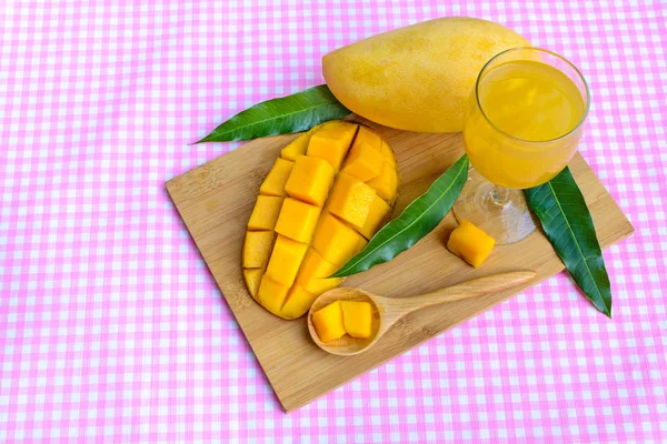 Yellow mango on wooden table — Stock Photo, Image