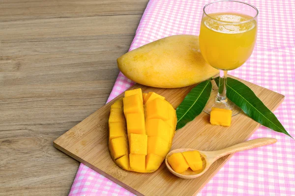 Yellow mango on wooden table — Stock Photo, Image