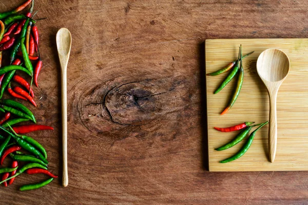 Chilli pepper on old wood background — Stock Photo, Image