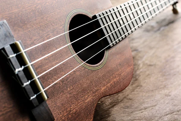 Close up of ukulele on old wood background with soft light — Stock Photo, Image