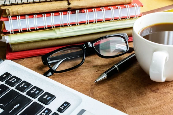 Portátil y taza de café con flores en el escritorio — Foto de Stock