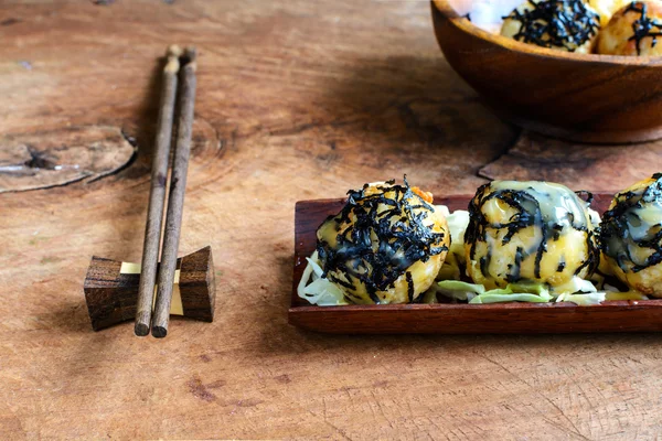 Poffertjespan op houten tafel met stokjes, Japans eten — Stockfoto