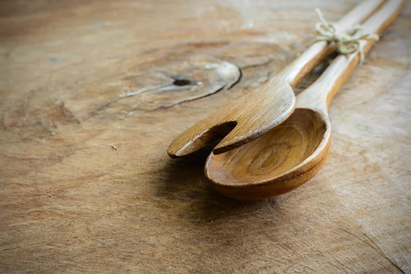 Wooden spoon and fork on old wooden table — Stock Photo, Image