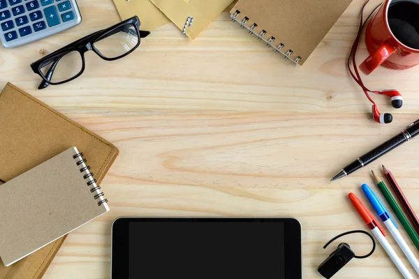 Notebook with cup of coffee and office supply on desk — Stock Photo, Image