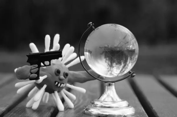 Figure Virus Toy Gun Next Small Glass Globe — Stock Photo, Image