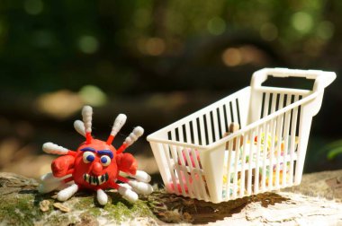 Bir plastik virüs biblosu ve yakın plan yiyecek için bir oyuncak sepet..