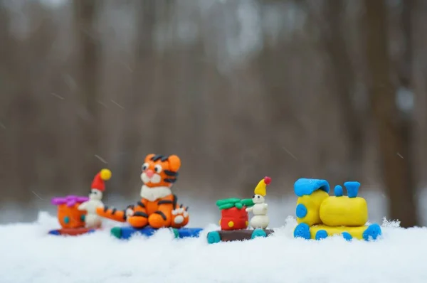 Toy train with fabulous toys. Tiger cub, snowman and Christmas gifts.