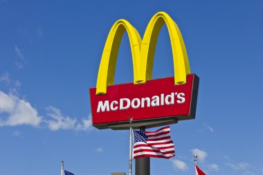 Indianapolis - Circa March 2016: McDonald's Restaurant Sign with American Flag. McDonald's is a Chain of Hamburger Restaurants III clipart