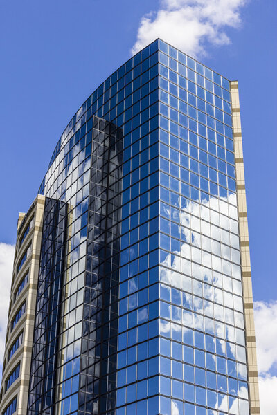 Indianapolis - Circa September 2016: Mirror Tile Window Skyscraper with Blue Sky and White Clouds in Reflection I