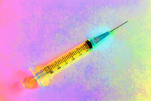 Syringe with hypodermic needle abstract. Opiate and heroin overdoses have skyrocketed in recent years.