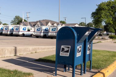 Monticello - Circa May 2021: USPS Post Office Mail Trucks. The Post Office is responsible for providing mail delivery. clipart