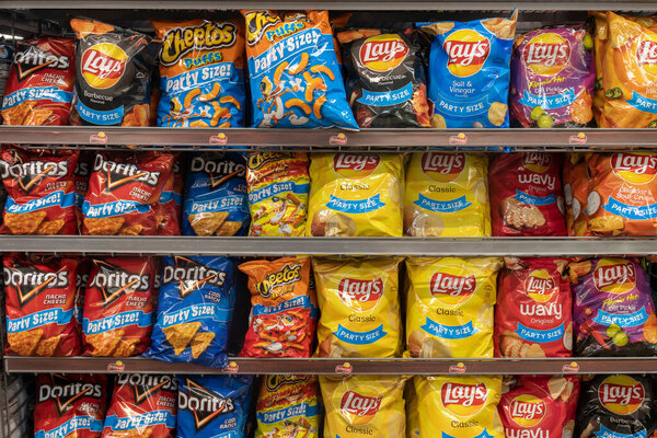 Cincinnati - Circa September 2021: Frito Lay potato and snack chip display. Frito-Lay is a subsidiary of PepsiCo and manufactures chips and other salty snacks.