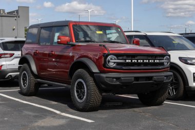 Plainfield - October 5, 2025: Ford Bronco Outer Banks 4X4 SUV at a dealership. Ford offers the Bronco with a 2.3L EcoBoost 4-Cylinder engine. MY:2024