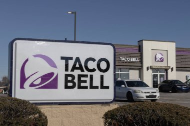 Indianapolis - November 22, 2025: Taco Bell fast food restaurant. Taco Bell specializes in Mexican-inspired food, including tacos, burritos, and quesadillas.