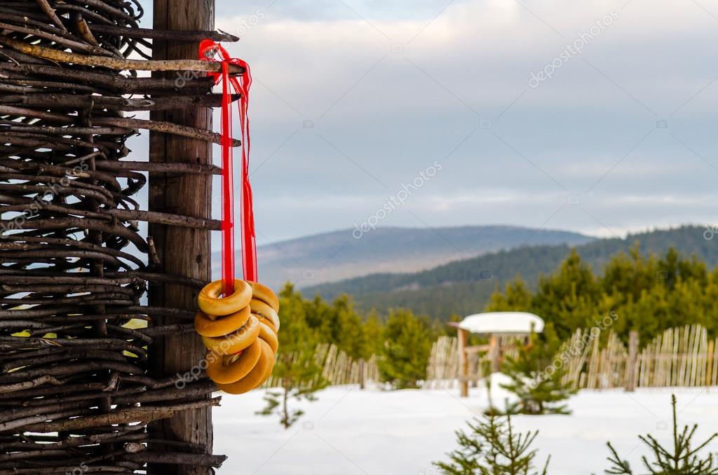 A bunch of bagels weighs on the pole in the Russian countryside in winter