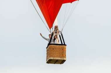 Man and woman flying in the hot air balloon clipart