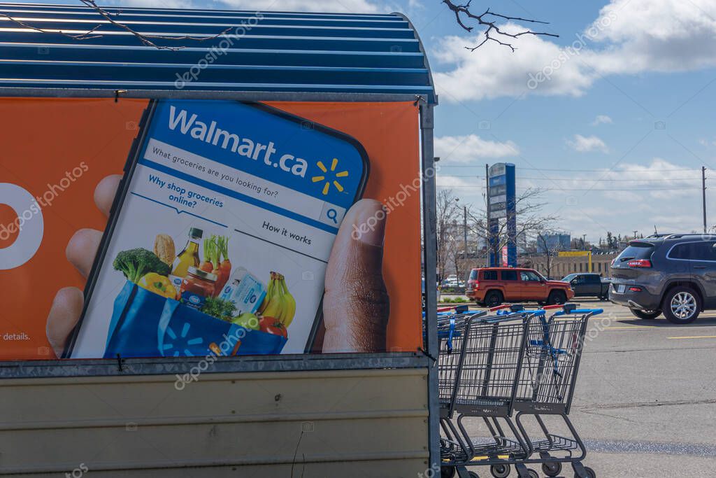 Toronto, Canada, April 2021 - A sign in the parking lot of a Walmart store for ordering groceries online and pickup