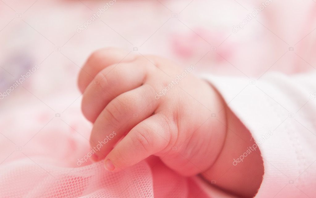 Cute newborn hand, pink color