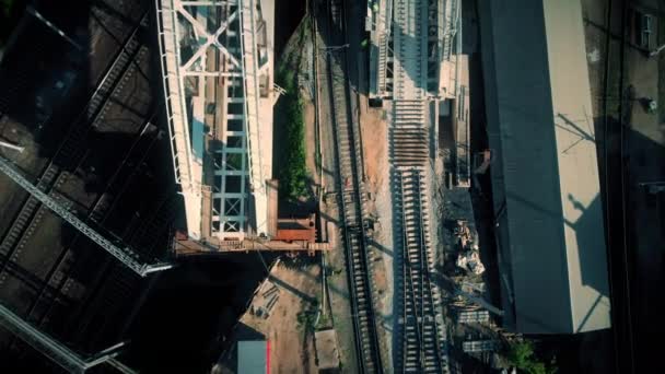 Construction of a railway bridge in the metropolis. Train rides, top view. Moscow, summer, day, taken from a copter. — Stock Video