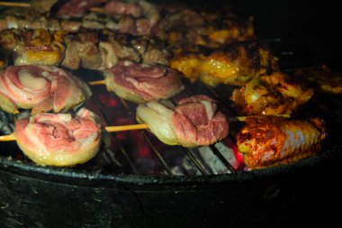 Meat and chicken butt barbecue on hot grill