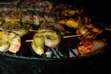 Meat and chicken butt barbecue on hot grill