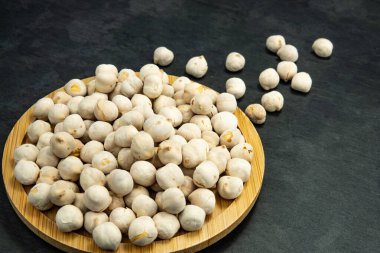 Beyaz nohutlar siyah bir taşın üzerine saçılmış..