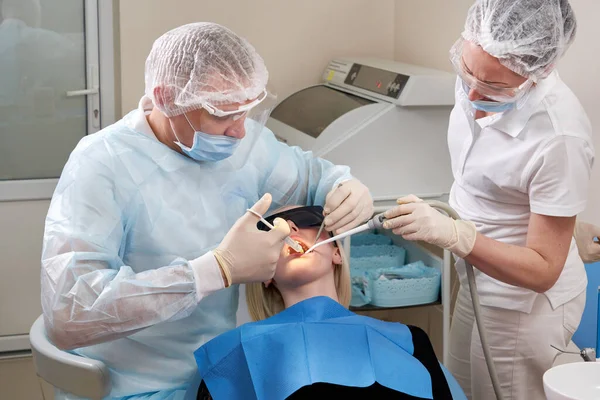 Dentist making local anesthesia shot before surgery.