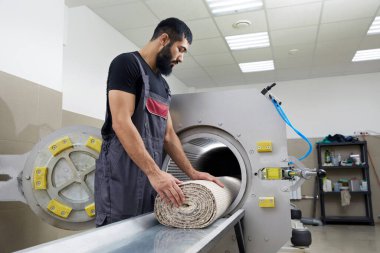 Halı temizleme için kurutma makinesi kullanan bir adam. Profesyonel halı temizleme servisi.
