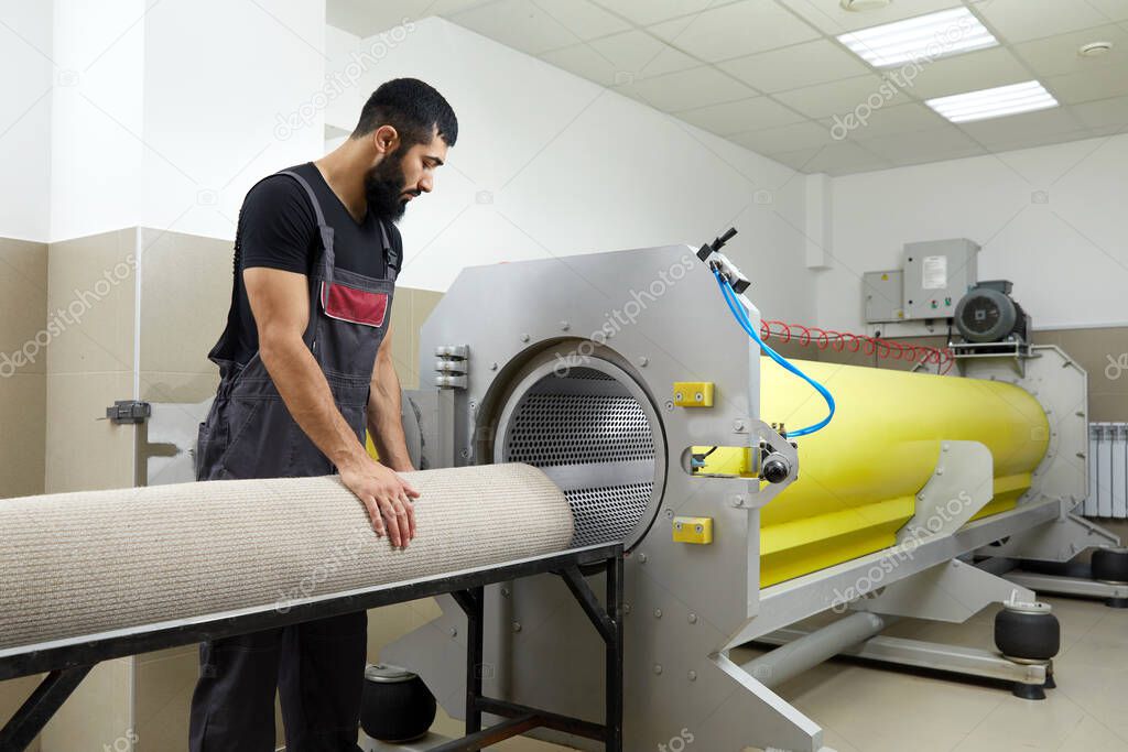 Man operating drying machine for carpet cleaning. Professional carpet cleaning service
